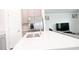 Kitchen island with stainless steel faucet and refrigerator with access to living room at 707 Staffora St, Haines City, FL 33844
