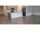 Modern kitchen featuring an island, stainless steel appliances, and stylish wood-look floors at 707 Staffora St, Haines City, FL 33844