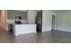 Well-equipped kitchen featuring gray cabinets, an island, and stainless steel appliances at 707 Staffora St, Haines City, FL 33844