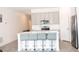 Bright kitchen with island seating, stainless appliances, and modern light gray cabinetry at 707 Staffora St, Haines City, FL 33844