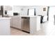 Modern kitchen island with stainless steel dishwasher and view into the living room at 707 Staffora St, Haines City, FL 33844