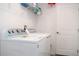 Bright laundry room showcases a washer, dryer, storage shelves, and a tidy layout at 707 Staffora St, Haines City, FL 33844