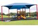 A colorful playground structure with a sunshade, offering a fun and safe play area at 707 Staffora St, Haines City, FL 33844