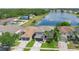Stunning aerial view showcasing the home's prime location near a lake, surrounded by lush greenery and a Gathering friendly community at 726 Lake Biscayne Way, Orlando, FL 32824
