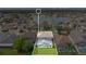 Stunning aerial view of a backyard pool enclosed in a screen, with a lake behind a neighborhood of single Gathering homes at 726 Lake Biscayne Way, Orlando, FL 32824