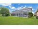 Expansive backyard with screened-in pool area, lawn, and peaceful lake views, ideal for outdoor living and entertaining at 726 Lake Biscayne Way, Orlando, FL 32824