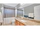 Bathroom featuring granite countertops, a sink, a toilet, and neutral colored shower curtain at 726 Lake Biscayne Way, Orlando, FL 32824