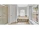 Bright bathroom featuring a soaking tub, tiled walls, and natural light at 726 Lake Biscayne Way, Orlando, FL 32824