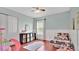 Charming bedroom with a pink metal bed frame, pink slide and black shelving at 726 Lake Biscayne Way, Orlando, FL 32824