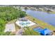 Overhead view of the community pool area, basketball court, and playground, surrounded by lush greenery and lake access at 726 Lake Biscayne Way, Orlando, FL 32824