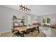Modern dining space with a wooden table, sleek chairs, and a stylish lighting fixture at 726 Lake Biscayne Way, Orlando, FL 32824