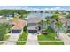 Beautiful two-story home with a well-kept lawn, palm trees, and a scenic lake view at 726 Lake Biscayne Way, Orlando, FL 32824