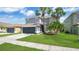 Stunning gray home with green lawn and palm trees, enhancing its curb appeal at 726 Lake Biscayne Way, Orlando, FL 32824
