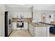 Well-lit kitchen with stainless steel appliances, granite countertops and a center island at 726 Lake Biscayne Way, Orlando, FL 32824