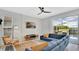 Inviting living room featuring a large window, blue sectional, and an entertainment center at 726 Lake Biscayne Way, Orlando, FL 32824
