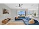 Bright living room with a blue sectional, large window views, and modern decor at 726 Lake Biscayne Way, Orlando, FL 32824