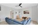 Stylish living room with a modern ceiling fan, TV, and a comfortable blue sectional at 726 Lake Biscayne Way, Orlando, FL 32824