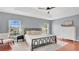 Spacious bedroom with tray ceiling, hardwood floors, and large windows at 726 Lake Biscayne Way, Orlando, FL 32824