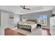 Serene bedroom featuring a tray ceiling, hardwood floors, and ample natural light at 726 Lake Biscayne Way, Orlando, FL 32824