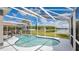 Inviting screened-in pool area, perfect for relaxation with comfortable seating and a tranquil pond view at 726 Lake Biscayne Way, Orlando, FL 32824