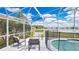 Relaxing screened-in lanai with pool and comfortable seating, offering serene lake views and outdoor enjoyment at 726 Lake Biscayne Way, Orlando, FL 32824
