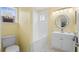 Well-lit bathroom featuring a shower-tub combo, a vanity, and a window at 754 Centervale Dr, Kissimmee, FL 34747