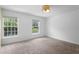 Bright bedroom featuring neutral carpet, natural light, and large windows at 754 Centervale Dr, Kissimmee, FL 34747
