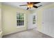Inviting bedroom featuring neutral carpet, a ceiling fan, and natural light at 754 Centervale Dr, Kissimmee, FL 34747