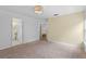 Spacious bedroom featuring neutral carpet, a ceiling fan and ensuite bathroom at 754 Centervale Dr, Kissimmee, FL 34747