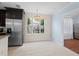 Dining area with stainless steel refrigerator and decorative chandelier at 754 Centervale Dr, Kissimmee, FL 34747