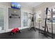 Well-equipped gym features exercise machines, a television, and natural light from the window at 754 Centervale Dr, Kissimmee, FL 34747