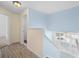 Upstairs hallway area with wood floors, natural light, and neutral color paint at 754 Centervale Dr, Kissimmee, FL 34747