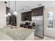 Modern kitchen with stainless steel appliances, granite countertops, and dark wood cabinets at 754 Centervale Dr, Kissimmee, FL 34747