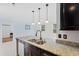 Kitchen island with granite countertops, stainless steel sink, and pendant lighting at 754 Centervale Dr, Kissimmee, FL 34747