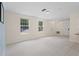 Bright, spacious living room with tile floors and two large windows at 754 Centervale Dr, Kissimmee, FL 34747