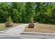 Cement walkway with two decorative potted trees alongside a lush, green lawn at 754 Centervale Dr, Kissimmee, FL 34747