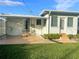 Back exterior view of home showing a covered patio and manicured lawn at 766 Canovia Ave, Orlando, FL 32804