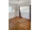Bedroom features hardwood flooring, a window for natural light, and a closet at 766 Canovia Ave, Orlando, FL 32804