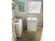 Functional laundry room featuring a washer, dryer, utility sink, and natural light from a window at 766 Canovia Ave, Orlando, FL 32804