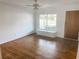 Bright living room features hardwood floors, a ceiling fan, and a large window at 766 Canovia Ave, Orlando, FL 32804