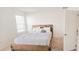 Cozy bedroom with neutral color walls, a wooden bed frame, and natural lighting at 853 Bocavista Ct, Davenport, FL 33896