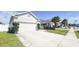 Charming single-Gathering home featuring a two-car garage, well-manicured lawn, and a lengthy driveway at 853 Bocavista Ct, Davenport, FL 33896