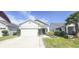 Charming single-story home with a well-maintained lawn and attached two-car garage at 853 Bocavista Ct, Davenport, FL 33896