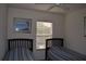 Comfortable bedroom with twin beds and a window offering natural light at 8564 Bay Lilly Loop, Kissimmee, FL 34747