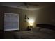 Serene main bedroom with a comfortable bed, soft lighting, and a window for natural light at 8564 Bay Lilly Loop, Kissimmee, FL 34747