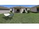 Spacious backyard with green grass, hammock, and patio set at 894 Pebble Crest Ln, Eagle Lake, FL 33839