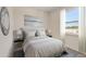 Cozy bedroom with a calming color palette, large window, and a decorative headboard at 894 Pebble Crest Ln, Eagle Lake, FL 33839