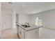Modern kitchen island with granite countertops and stainless steel sink, perfect for meal preparation at 894 Pebble Crest Ln, Eagle Lake, FL 33839