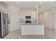Bright kitchen featuring stainless steel appliances, granite countertops, white cabinets and a kitchen island at 894 Pebble Crest Ln, Eagle Lake, FL 33839