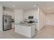 Kitchen featuring stainless steel appliances, granite countertops, white cabinetry, and a center island with sink at 894 Pebble Crest Ln, Eagle Lake, FL 33839